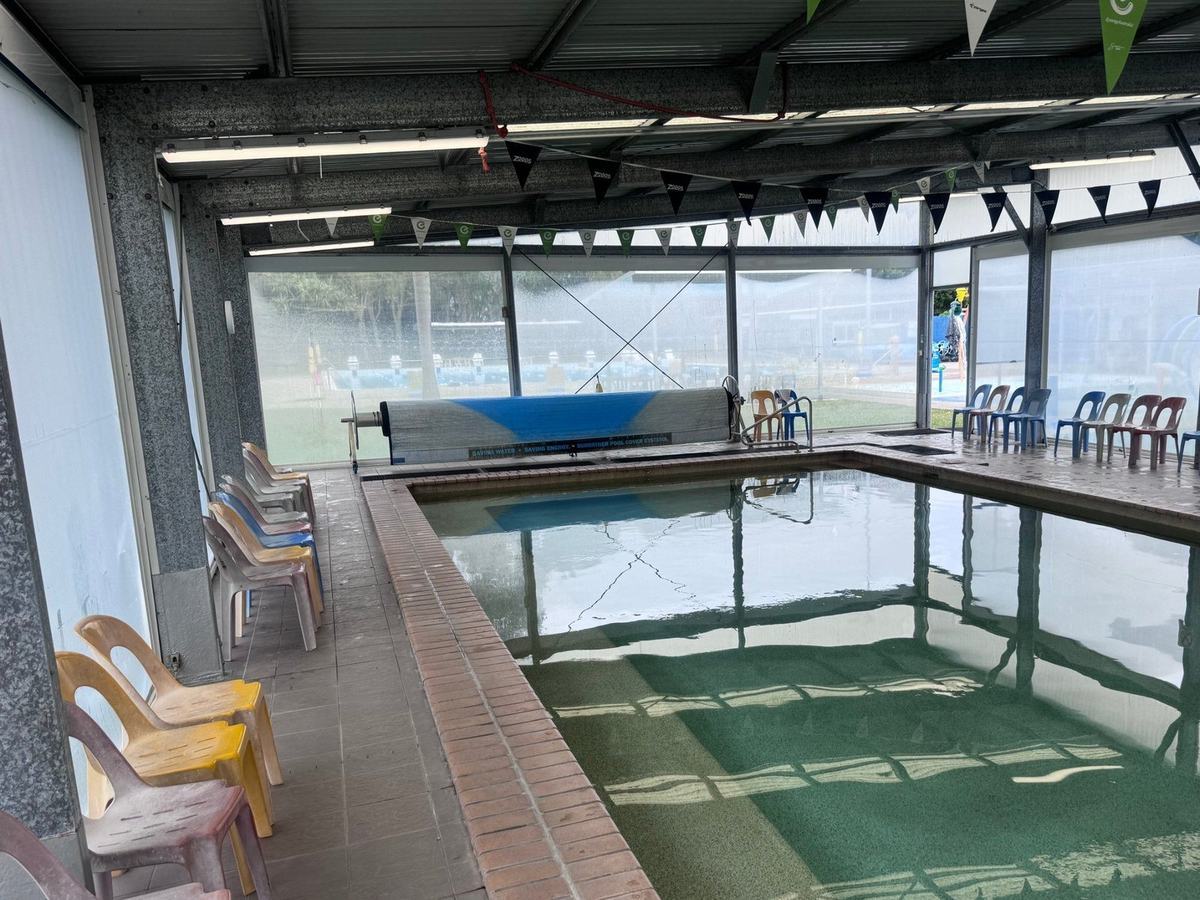 Enclosed learn to swim pool at Coolum Peregian Aquatic Centre with tiled deck and coping